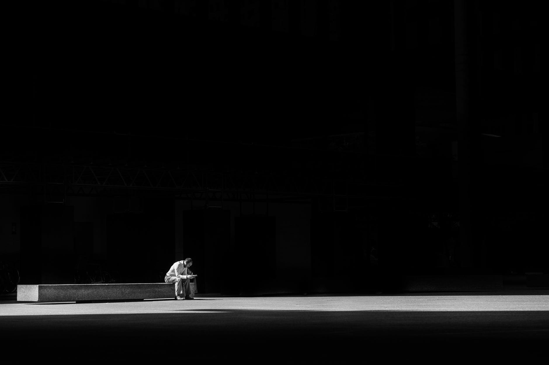 man sitting on a concrete bench